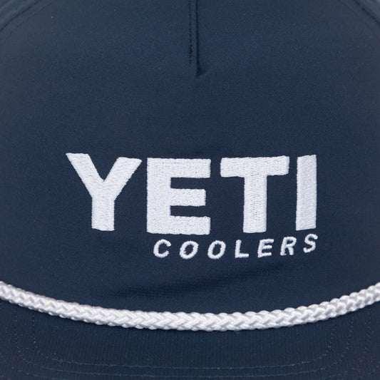 Close-up Navy blue cap with 'YETI Coolers' logo on a white background