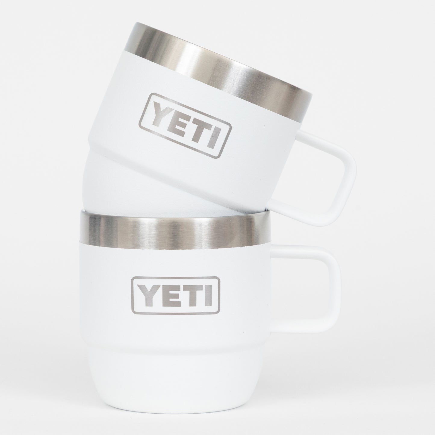 White YETI tumblers with silver insulation on a white background
