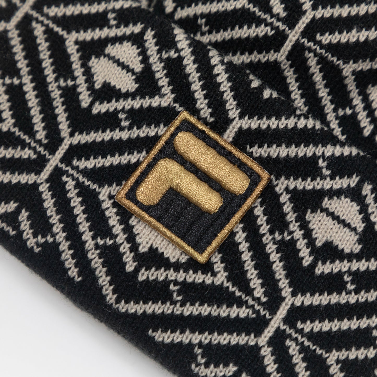 FILA Griggs Pattern Monogram Beanie in BLACK & GOLD