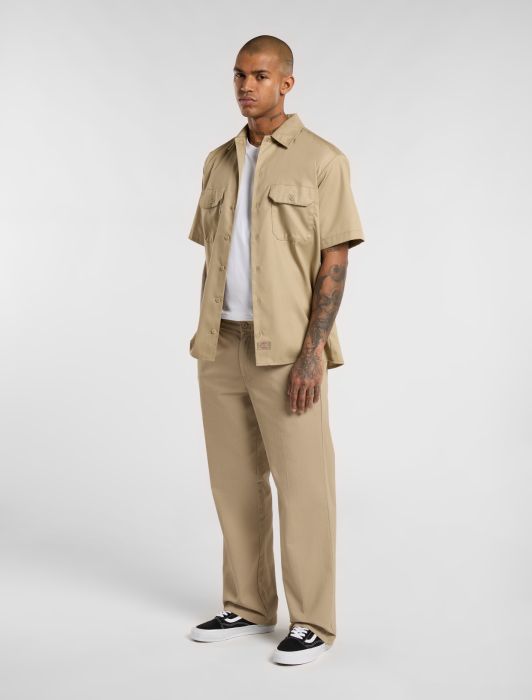 Man wearing dickies 247 work trousers on a white background