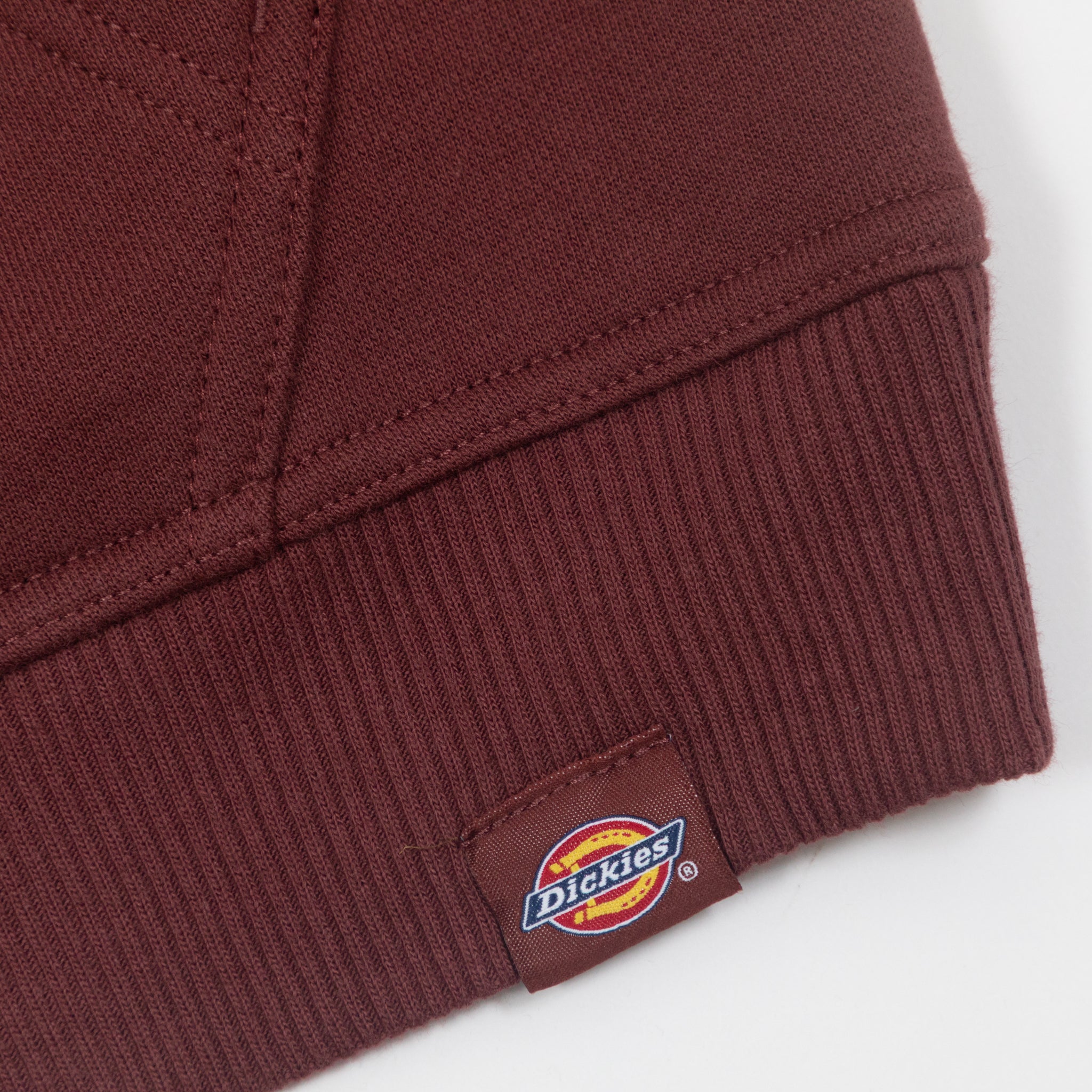close-up of dickies logo tab on brown womens hoodie