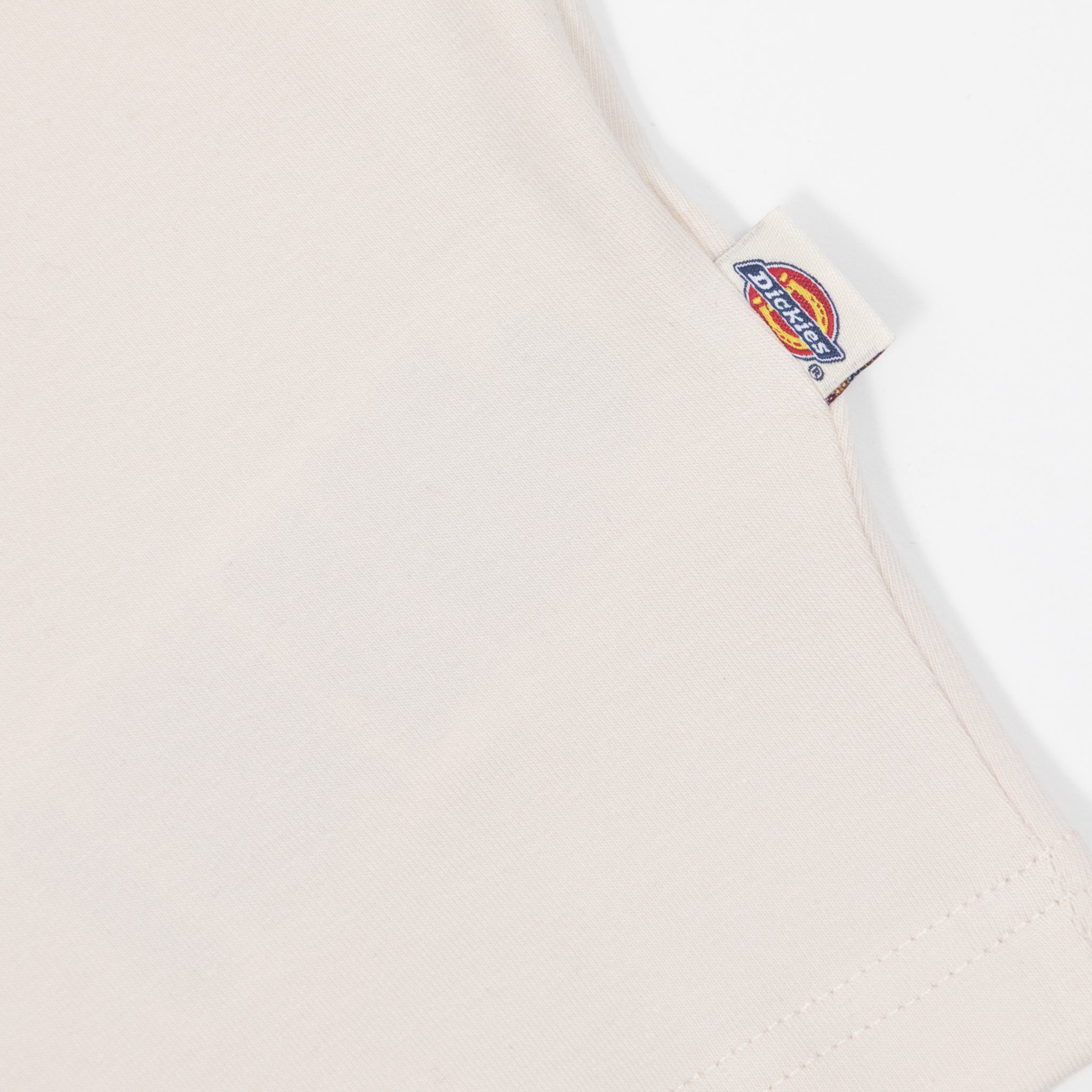 Close-up of dickies logo tab on cream t-shirt