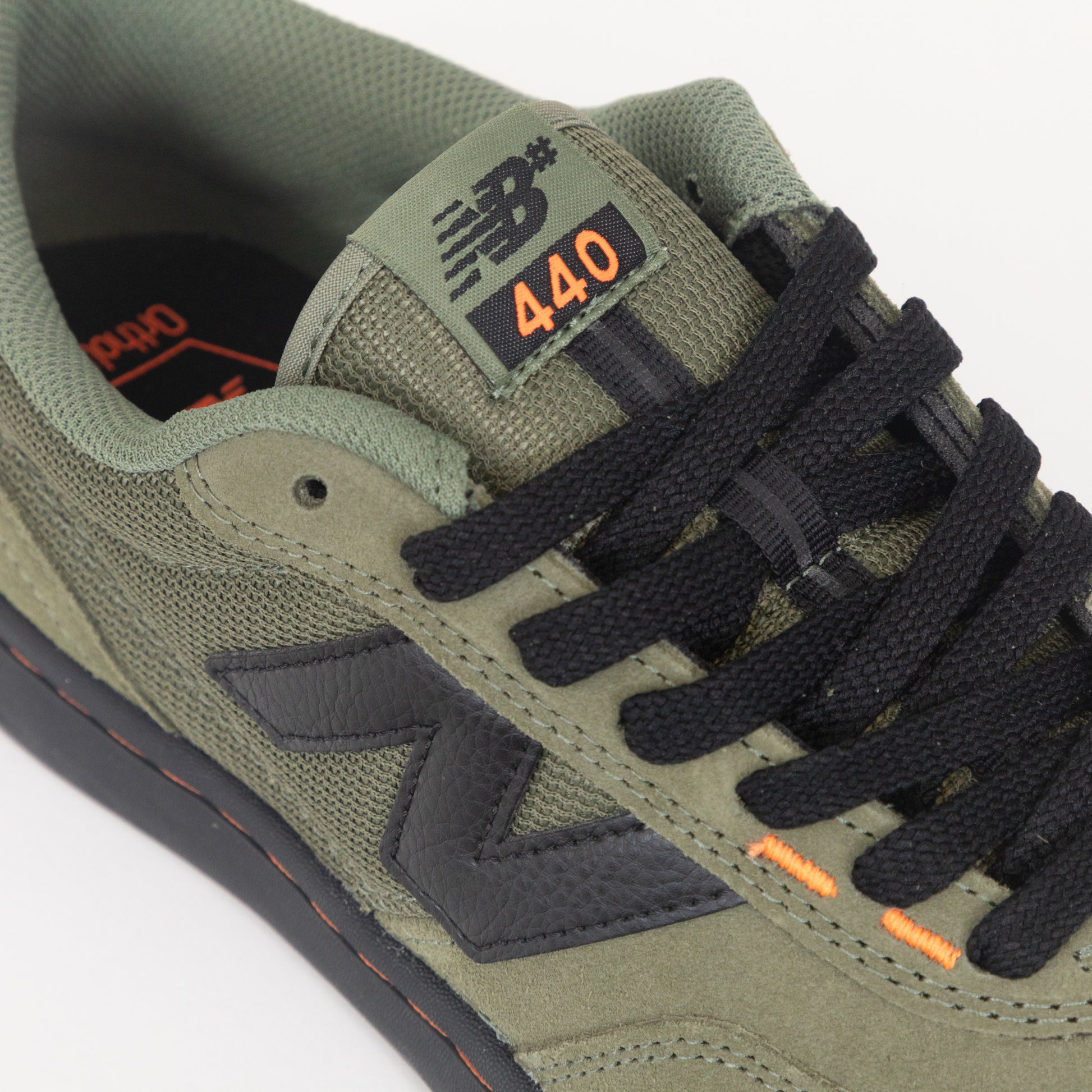 Green sneaker with black laces and '440' branding on a white background