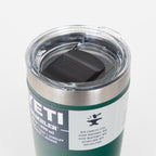 Green YETI tumbler with clear lid on a white background