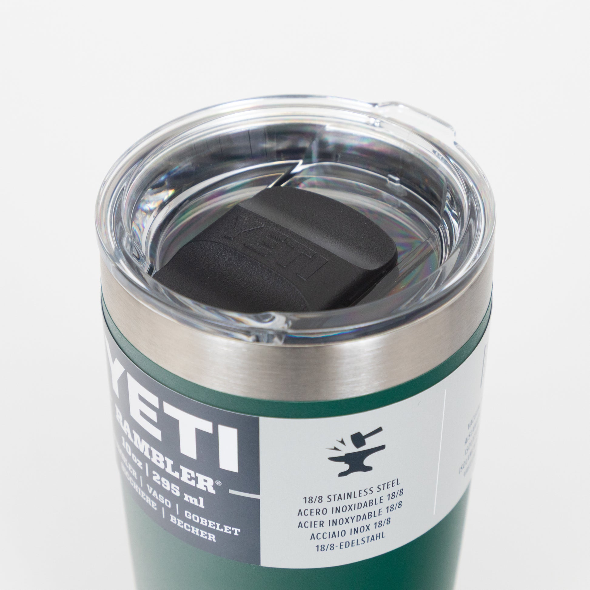 Green YETI tumbler with clear lid on a white background