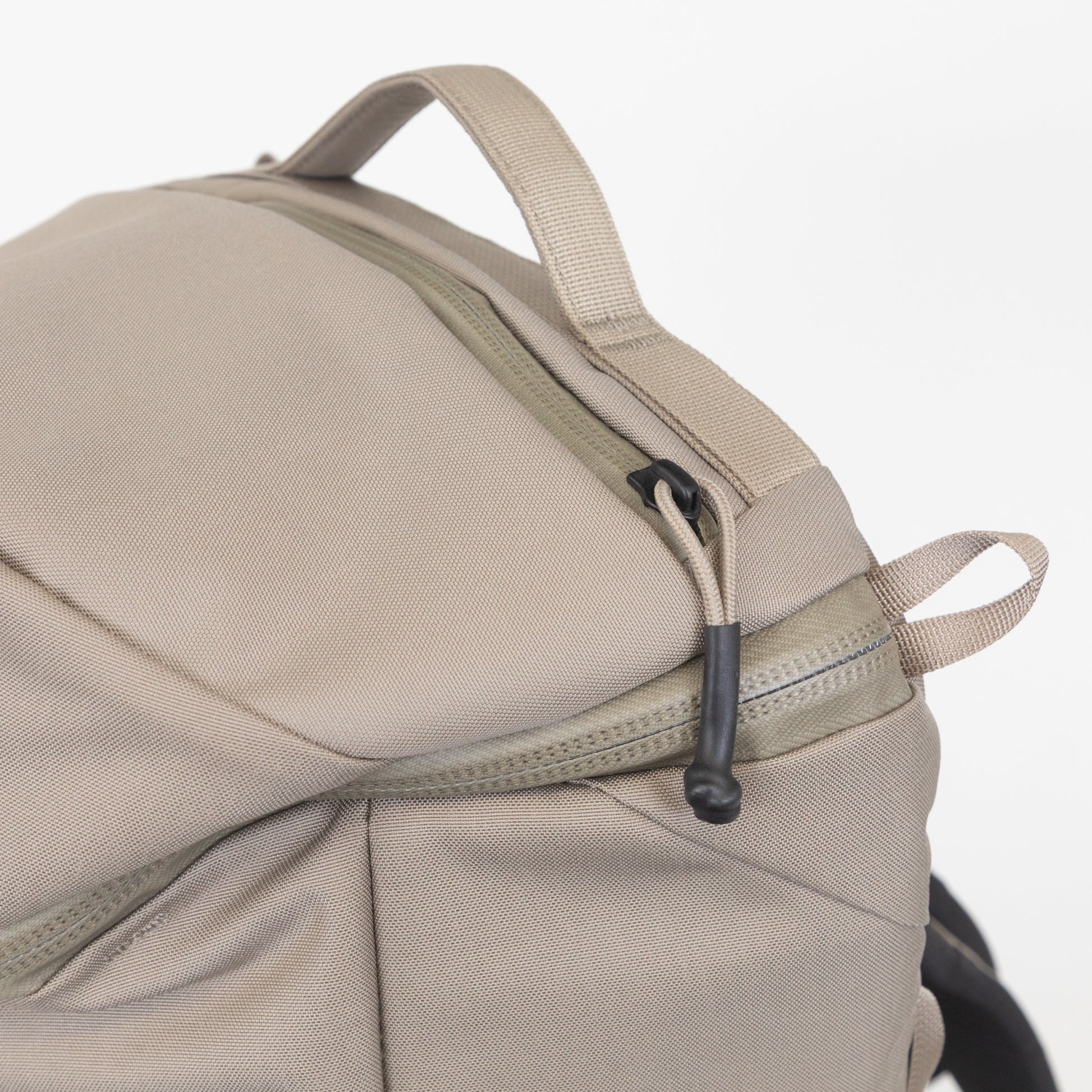 Close-up of YETI beige backpack with a zipper compartment