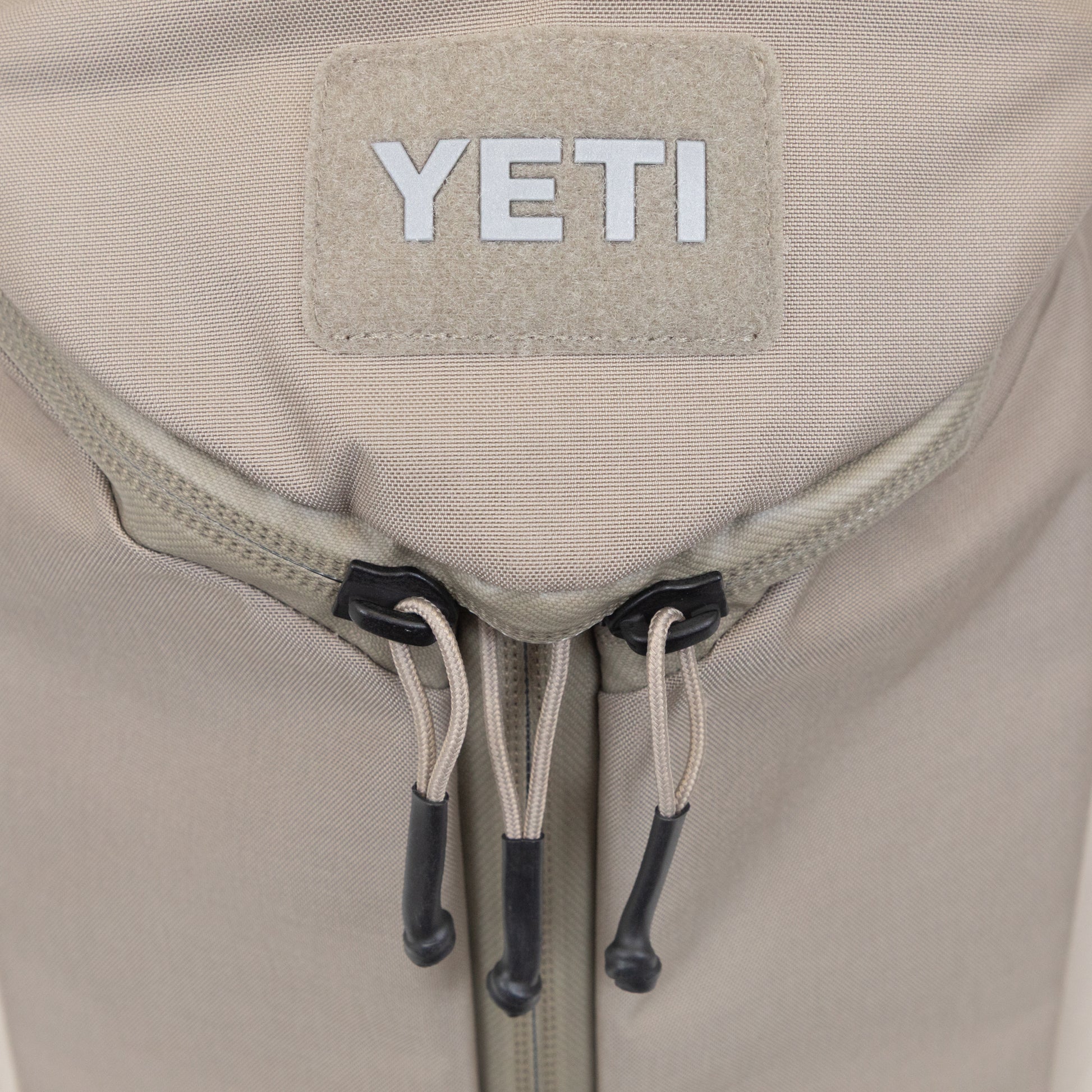 YETI beige backpack three zippers for easy access