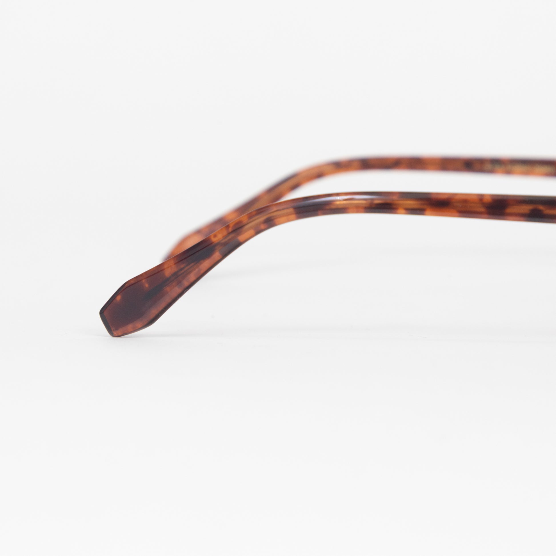 Close-up of tortoiseshell eyeglass frame on a white background