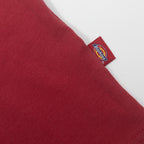 Red fabric with a visible brand tag on a white background