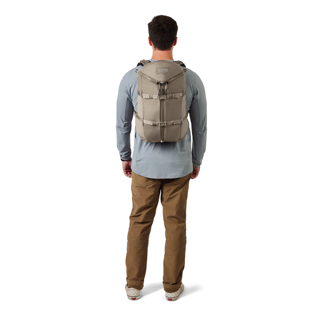 Man wearing YETI beige backpack 