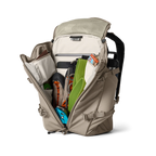 YETI Open beige backpack with various items on a white background