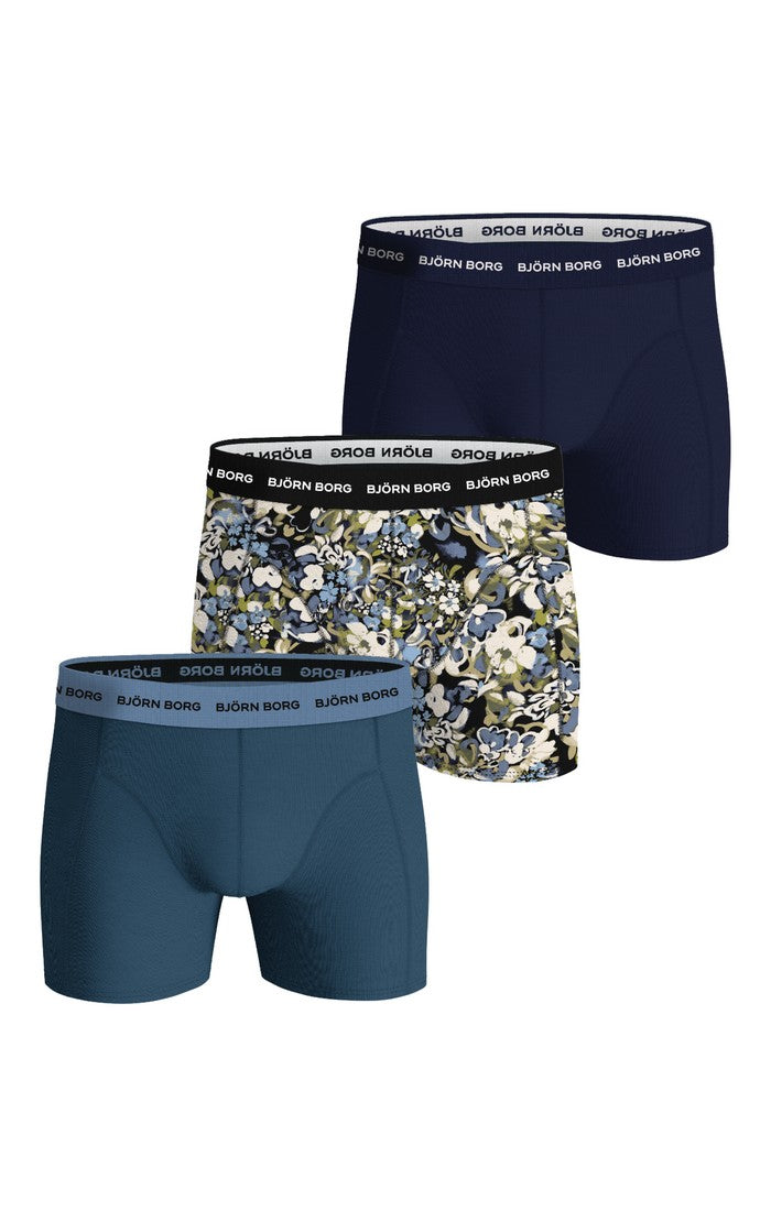 Three pairs of men's boxer briefs with different patterns on a white background
