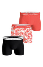 Three pairs of boxer briefs in black, red, and patterned design on a white background.