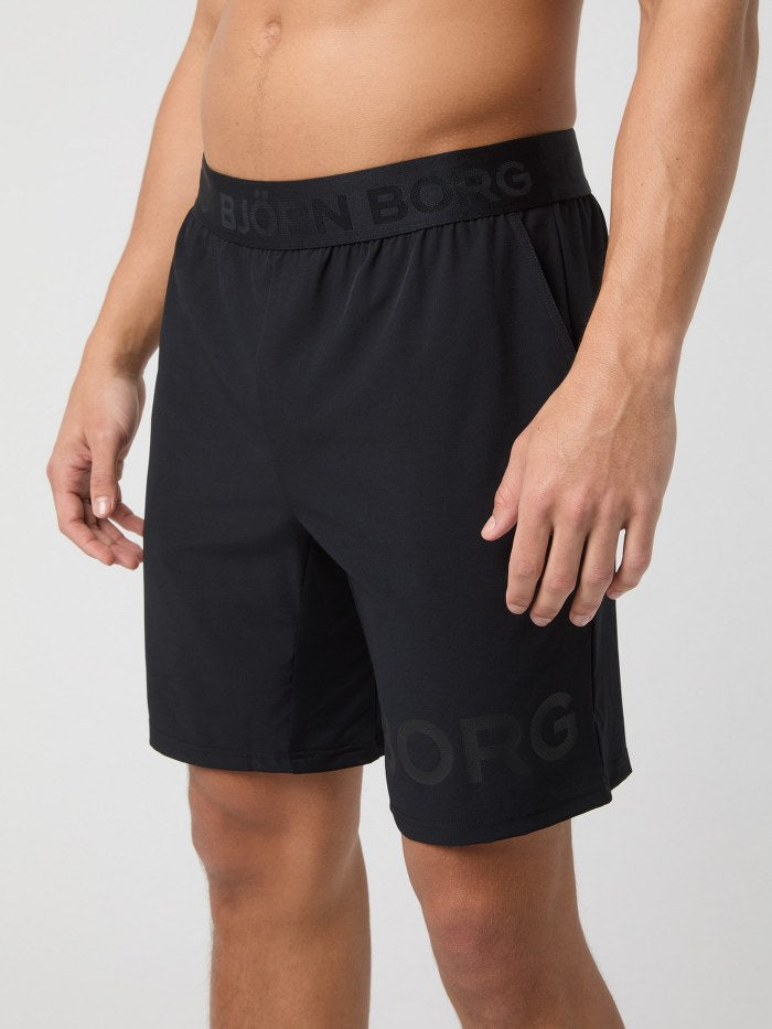 Black athletic shorts with 'Bjärn Borg' branding on a white background