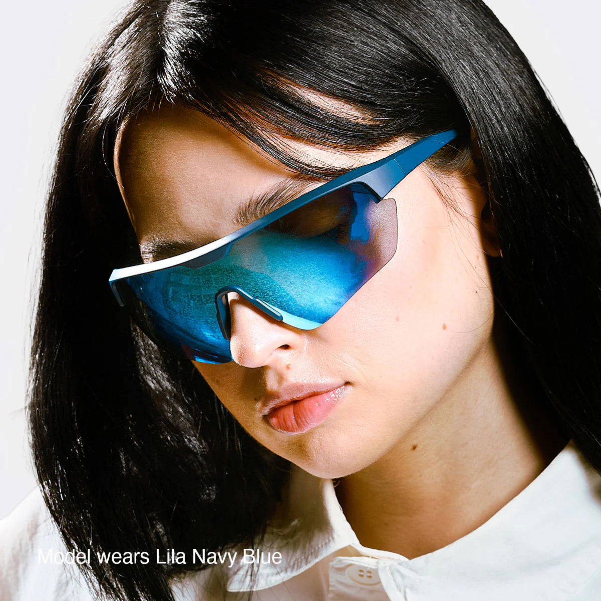 Person wearing meller blue sunglasses with a white background